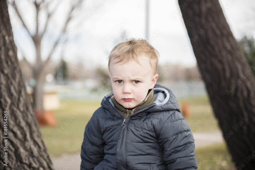 Portrait of a Toddler Boy Outside at a Local Park. Dressed Warmly for Winter. Portrait of a Toddler Boy Outside at a Local Park. Dressed Warmly for Winter.