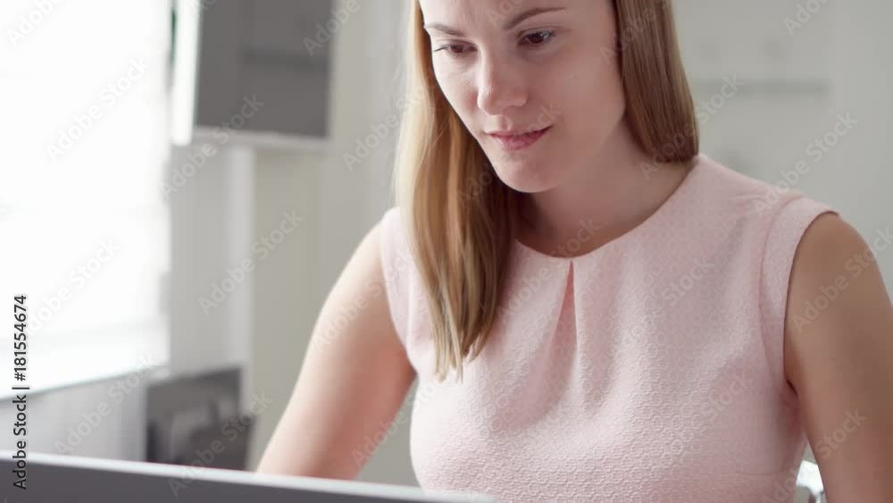 Young professional woman working on laptop computer at home. Remote freelance or office work, Student studying at home Young professional woman working on laptop computer at home. Remote freelance or office work, Student studying at home