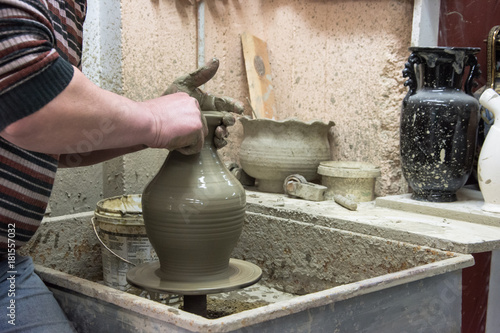 Man potter at work creating some traditional cups of white clay, Psychro, Lassithi, Crete, Greece.