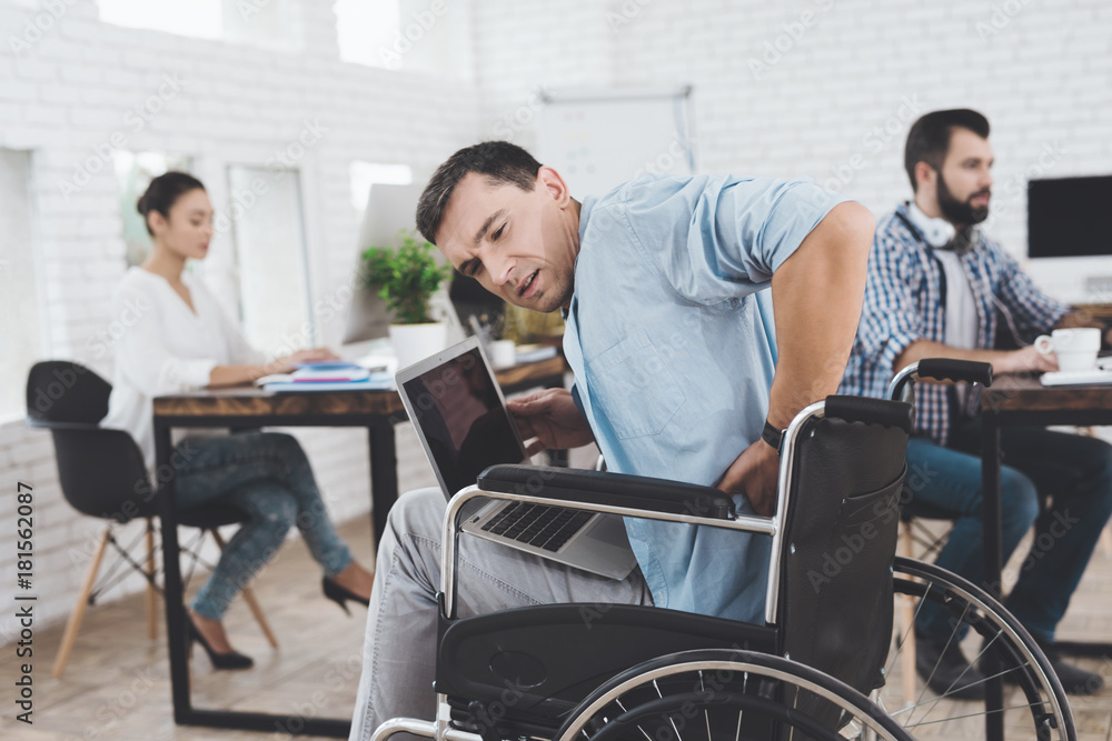 Disabled person in the wheelchair works in the office. He feel desease. Disabled person in the wheelchair works in the office. He feel desease.