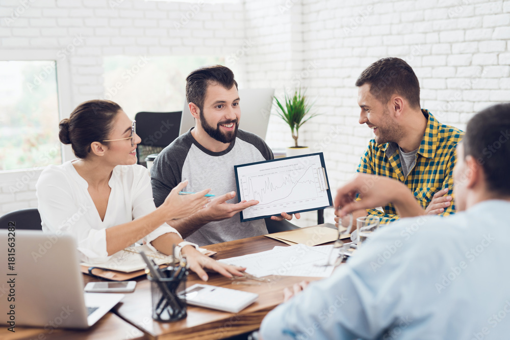 A man demonstrates business graphics. His collegues are listening to him. A man demonstrates business graphics. His collegues are listening to him.