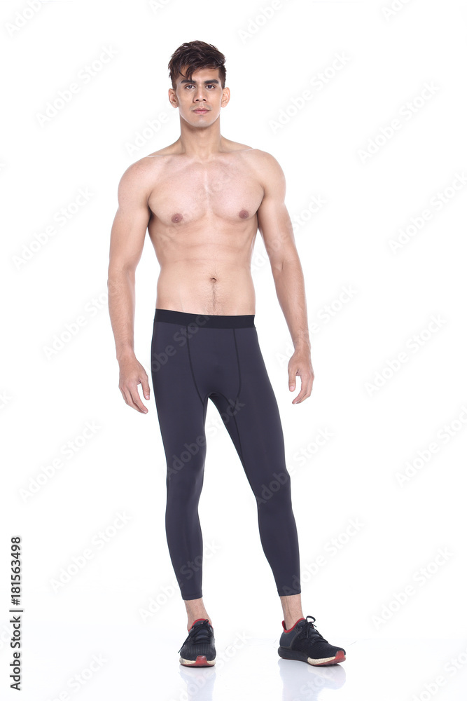 Full body length portrait of a young man wearing fitness sporty outfit