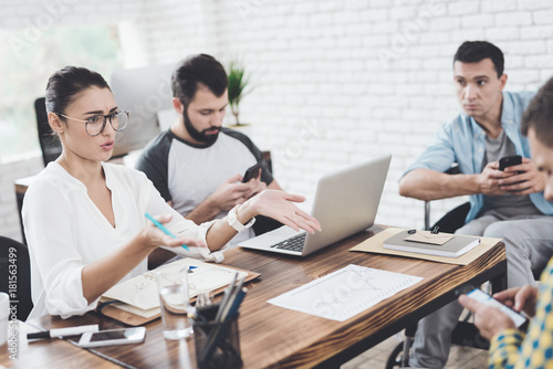 The girl is indignant during a business meeting in a modern office.