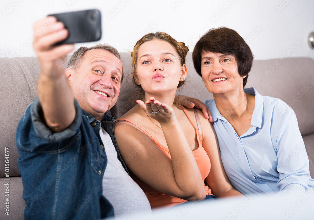 Happy family is taking selfie on the phone