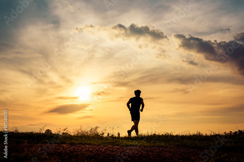 Fototapeta Naklejka Na Ścianę i Meble -  Silhouette man running on sunset