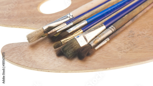 Paint brushes and artist palette, isolated on white background.