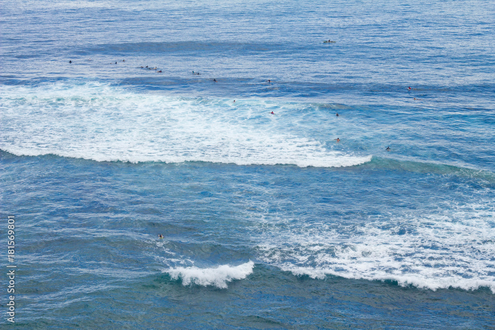 Surfers are waiting for waves in Uluwatu, Bali Surfers are waiting for waves in Uluwatu, Bali