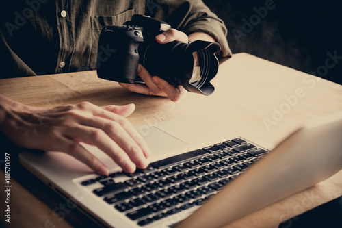 Obraz na płótnie Close up of photographer editing his images on laptop.
