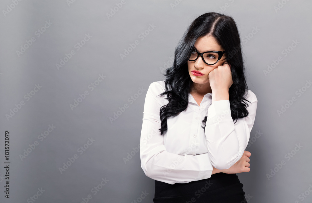 Young businesswoman in a thoughtful pose on a solid background Young businesswoman in a thoughtful pose on a solid background