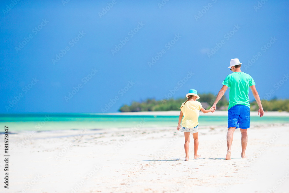 Little girl and dad during tropical beach vacation Little girl and dad during tropical beach vacation