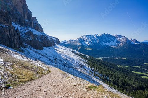 Hiking track with snow in Dolomites Alps, Rosengarden Group, South Tirol, Italy. photo