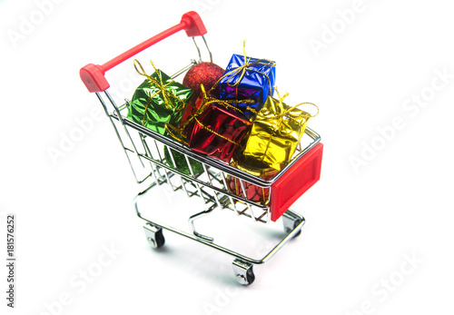 Christmas ornaments in shopping cart isolated on white background 