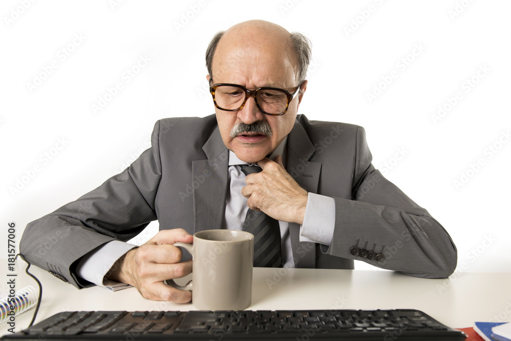 business man 60s working stressed and frustrated at office computer laptop desk looking tired and overwhelmed business man 60s working stressed and frustrated at office computer laptop desk looking tired and overwhelmed