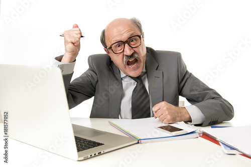 bald business man 60s working stressed and frustrated at office computer laptop desk looking tired