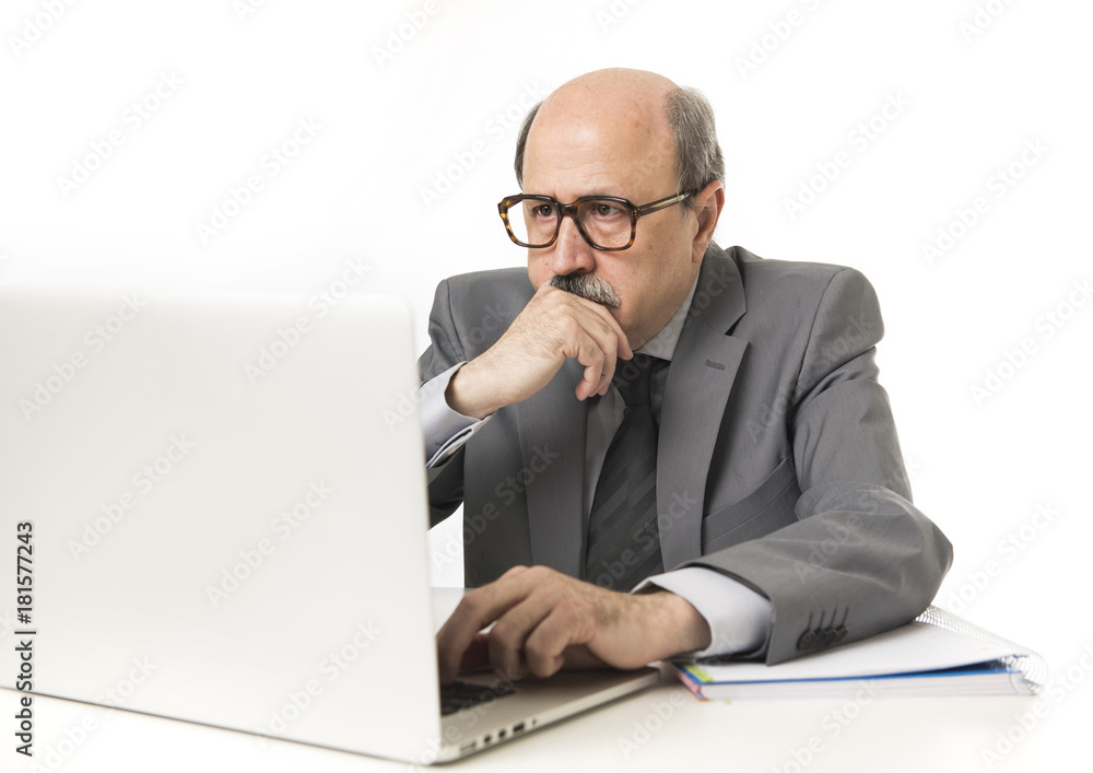 corporate portrait bald 60s serious and bossy business man thinking and working at computer laptop office desk corporate portrait bald 60s serious and bossy business man thinking and working at computer laptop office desk