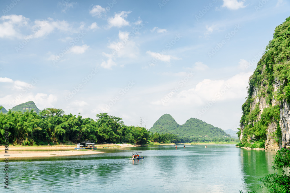 View of tourist motorized rafts on the Li River, Yangshuo