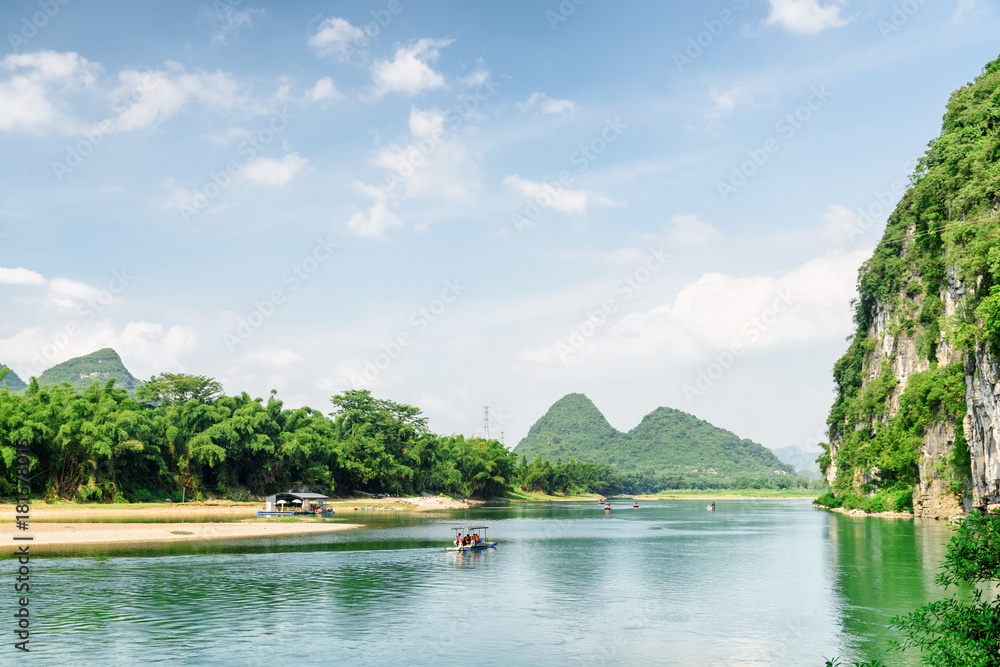 View of tourist motorized rafts on the Li River, Yangshuo View of tourist motorized rafts on the Li River, Yangshuo