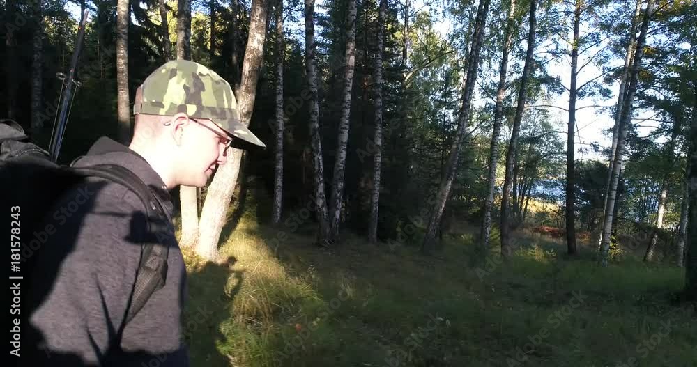 Man in the forest, Cinema 4k sideway view of a hiker, walking in a wild forest, on a sunny autumn day, in Raasepori, Uusimaa, Finland Man in the forest, Cinema 4k sideway view of a hiker, walking in a wild forest, on a sunny autumn day, in Raasepori, Uusimaa, Finland