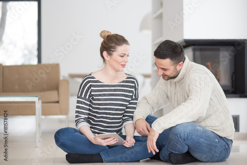 Young Couple using digital tablet on cold winter day