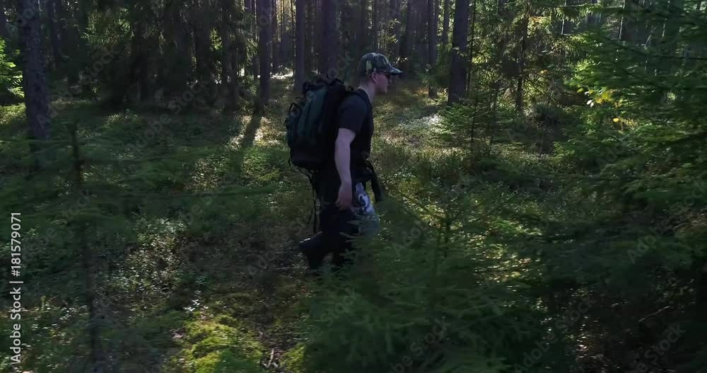 Man in the forest, Cinema 4k sideway view of a hiker, walking in a green forest, on a sunny autumn day, in Raasepori, Uusimaa, Finland Man in the forest, Cinema 4k sideway view of a hiker, walking in a green forest, on a sunny autumn day, in Raasepori, Uusimaa, Finland