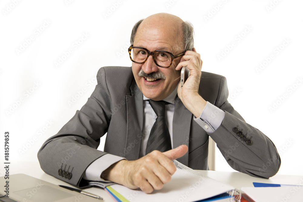 mature senior business man talking on mobile phone at office desk working happy and gesturing funny mature senior business man talking on mobile phone at office desk working happy and gesturing funny