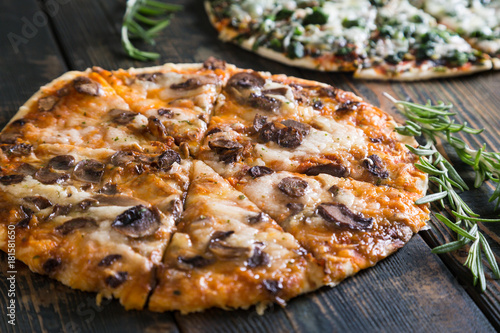 Pizza with mushrooms and cheese on thin dough