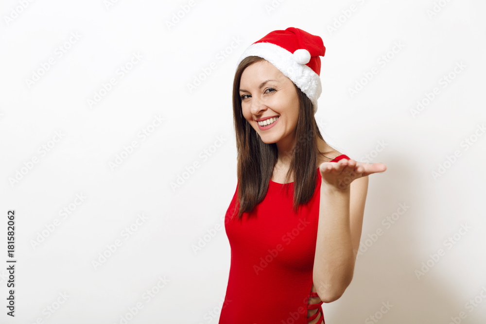Pretty caucasian happy woman with charming smile wearing red dress and Christmas hat looking camera, holding copy space on palm isolated on white background. Santa girl. New Year holiday 2018 concept Pretty caucasian happy woman with charming smile wearing red dress and Christmas hat looking camera, holding copy space on palm isolated on white background. Santa girl. New Year holiday 2018 concept