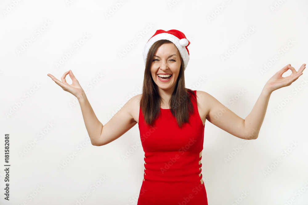 Beautiful funny caucasian young happy woman with charming smile wearing red dress and Christmas hat laughing meditating on white background. Santa girl isolated. New Year holiday 2018 concept Beautiful funny caucasian young happy woman with charming smile wearing red dress and Christmas hat laughing meditating on white background. Santa girl isolated. New Year holiday 2018 concept