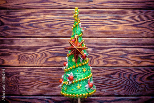  Christmas tree on the brown wooden background 