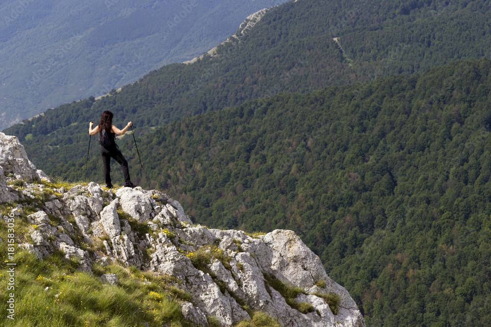woman hiker on green mountain