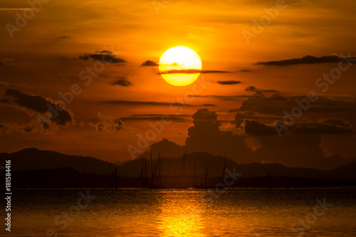 Sunset at the lake with dark cloud. © noppharat