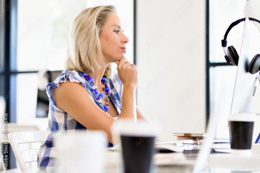 Portrait of businesswoman working at computer in office Portrait of businesswoman working at computer in office