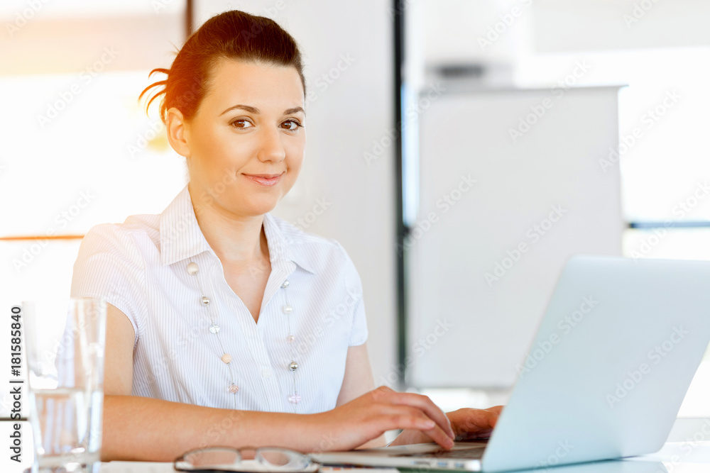 Portrait of businesswoman working at computer in office Portrait of businesswoman working at computer in office