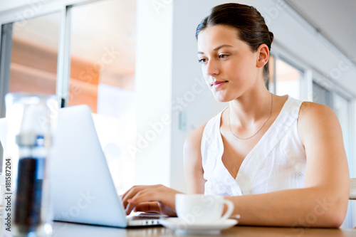 Young beautiful woman working on her laptop