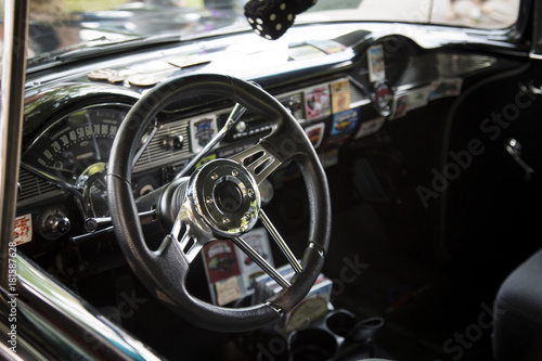 Isolated Interior View of Restored Tricked Out Vintage 50s Automobile Dashboard, Steering Wheel,  and Fabric Seats © Jacquie Klose