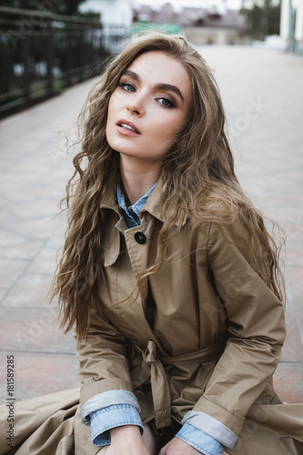 beautiful girl sitting on the stairs alone on the street