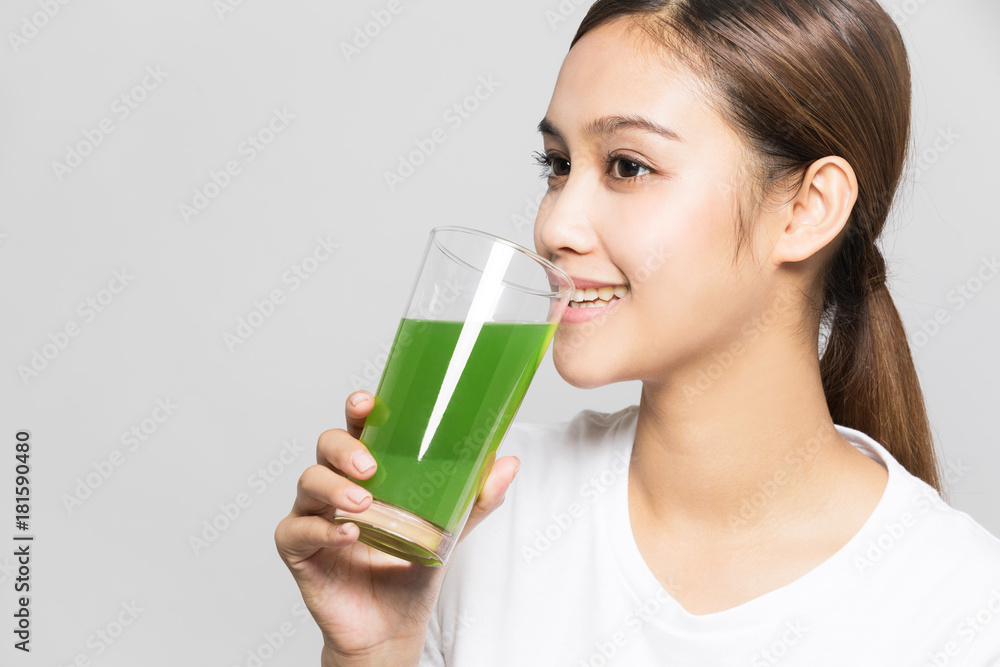 Young woman drinking a glass of vegetable juice. Young woman drinking a glass of vegetable juice.