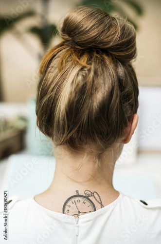 Rear view of woman with tattoo on her neck