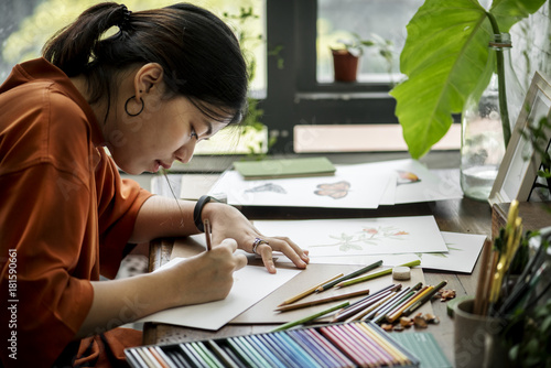 Asian woman is working on her hand drawing artwork photo