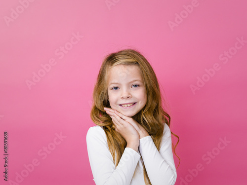 portrait of blond pretty girl in front of pink background with different emotions in the studio © epiximages