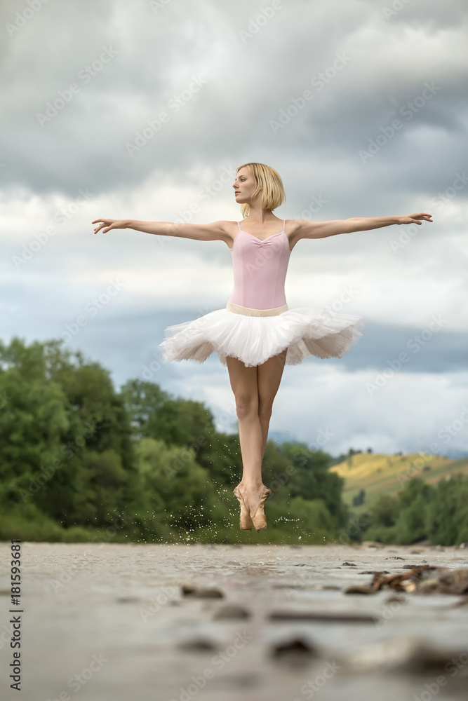 Ballerina jumping above river
