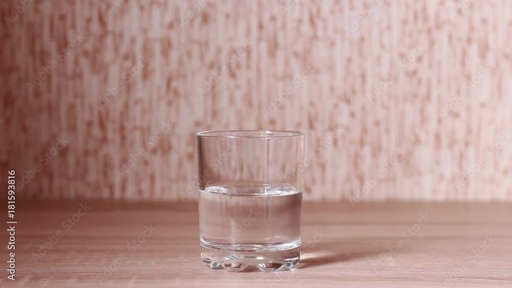 Tremored hand taking a glass of gin Tremored hand taking a glass of gin