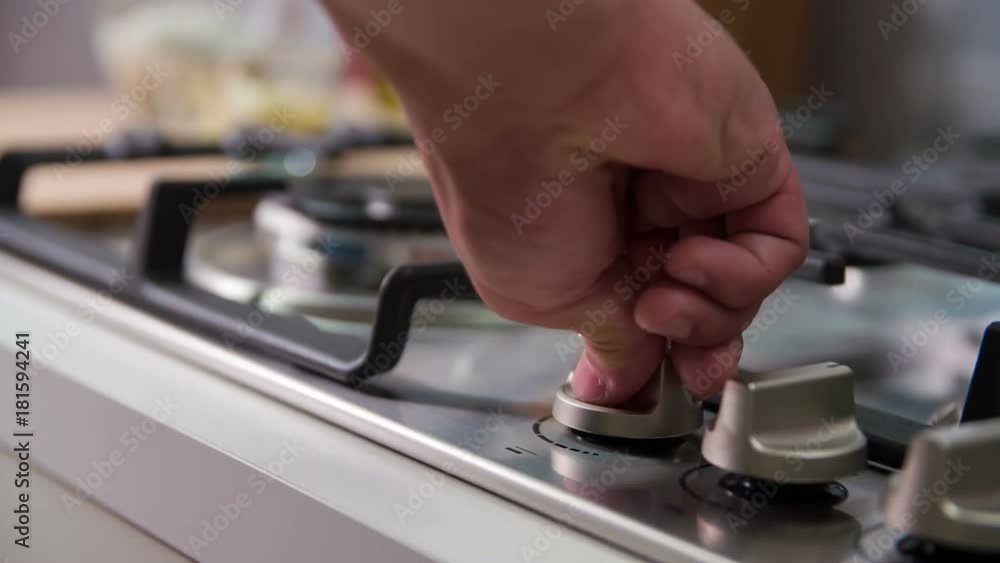 Superior cook turns knob top valve to turn the gas on and starts preparing delicious and healthy meal for the guests. Superior cook turns knob top valve to turn the gas on and starts preparing delicious and healthy meal for the guests.