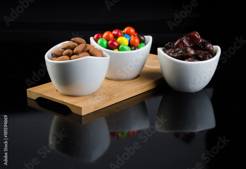 almond, chocolate and date on a background