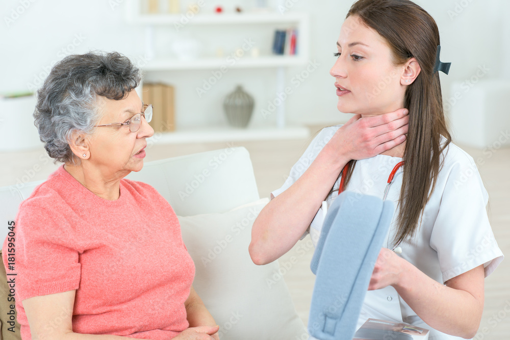 nurse explaining old female patient how to use medical assistance nurse explaining old female patient how to use medical assistance