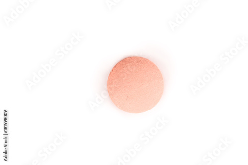 close-up of a salmon pink pill from above isolated on a white background.psd