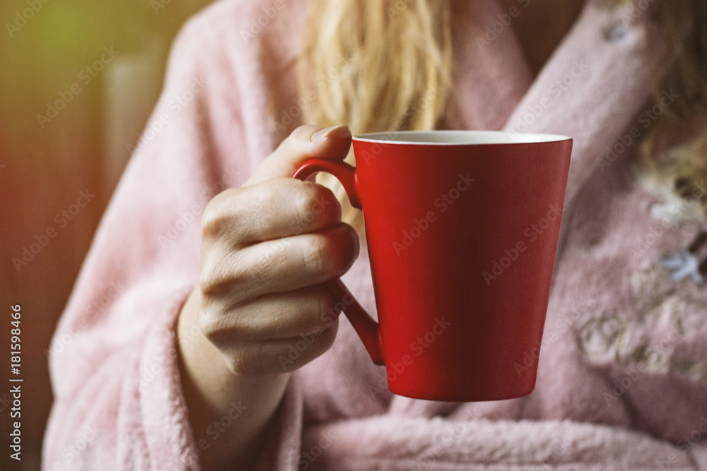 woman in a pink robe holds a cup. Added effect woman in a pink robe holds a cup. Added effect
