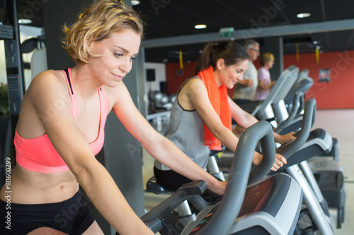 brunette girl and other females working out in sport club