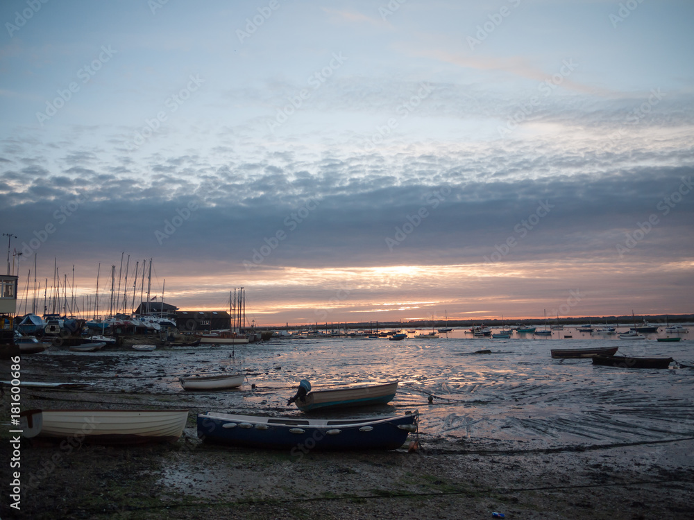Fototapeta premium sun set sky dramatic clouds sea front beach harbor marina boats moored landscape