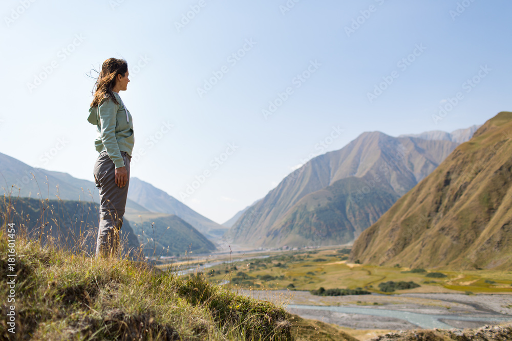 woman admires the view of the mountains